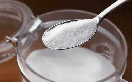 Một người phụ nữ trẻ đang súc miệng bằng nước muối, thể hiện sự chăm sóc sức khỏe răng miệng hàng ngày.